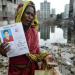 A mourner holds up a portrait of her missing relative following the 2013 collapse of the Rana Plaza garment building near Dhaka, Bangladesh © Getty Images