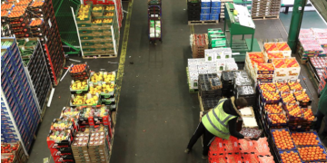FILE PHOTO: Workers inspect fruit and vegetables on display at the New Covent Garden wholesale market in London, Britain, February 3, 2018. REUTERS/Simon Dawson