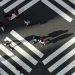 People cross a street in front of Shinjuku station, a normally crowded street during the weekend.