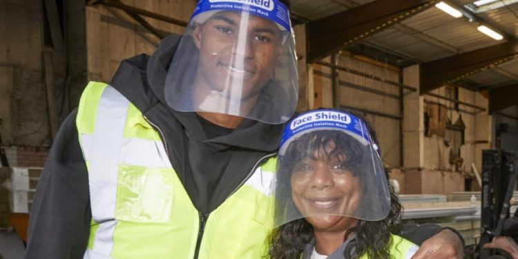 Marcus Rashford and his mother Melanie helping out a food bank. Pic:Mark Waugh/FareShare
